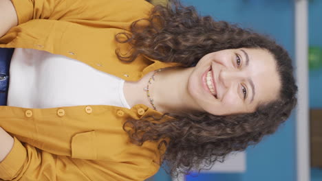Vertical-video-of-Young-woman-winking-at-camera.